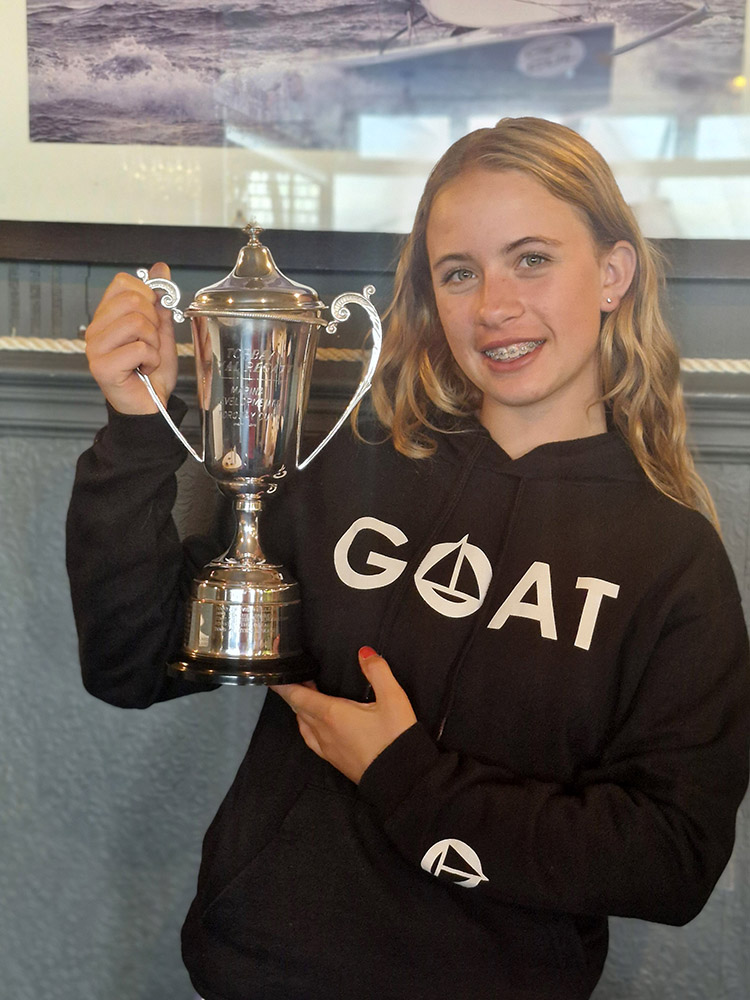 Girl holding up silver trophy